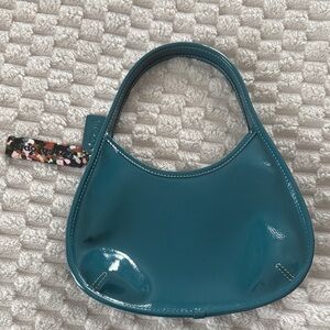 Coachatopia patent leather shoulder bag in teal green.